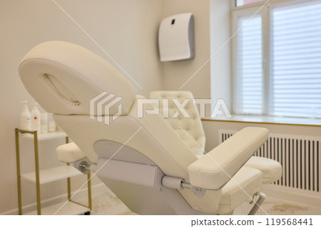 Modern spa with white massage chair and luxurious marble flooring for serene relaxation 119568441