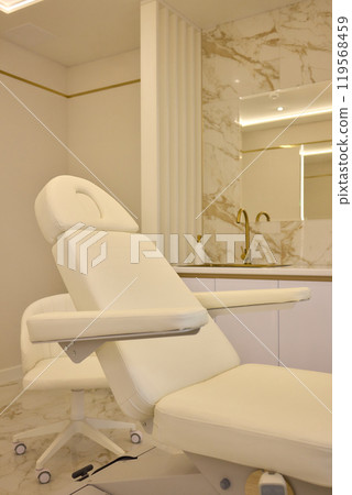 Modern spa with white massage chair and luxurious marble flooring for serene relaxation 119568459