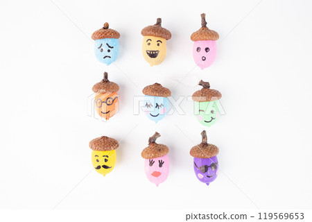 Colorful hand painted acorns collection with various facial expressions on a white. craft projects and autumn decorations. DIY and creativity concept, 119569653