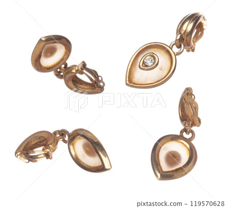 Fashion gold Earrings with beautiful work detail is value. Luxury golden earring is fashion trend and fly in air. White background isolated Fashion gold Earrings with beautiful work detail is value. Luxury golden earring is fashion trend and fly in air. White background isolated 119570628