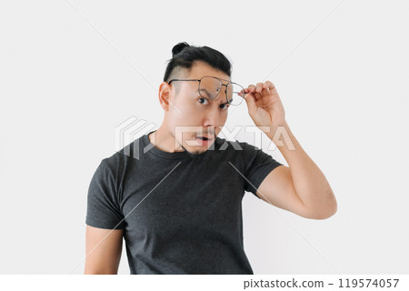 Serious angry face freelance man bun hair in black on white. Serious angry face freelance man bun hair in black on white. 119574057