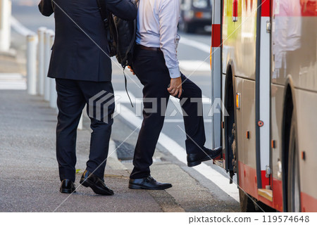 Male commuter boarding a bus 119574648