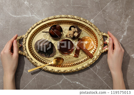 Hot Turkish tea in a glass on a golden tray 119575013