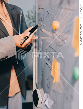 Business people are analyzing and planning business strategies. 119575596