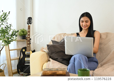 Beautiful woman freelancer working on a laptop in a living space at home 119576228