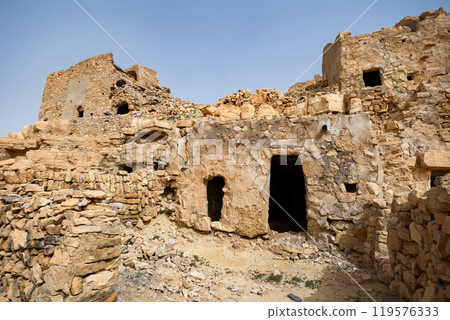 Ancient stone houses and on the mountain slopes in Guermassa region. South Tunisia. Tatouine governorate,Tunisia 119576333