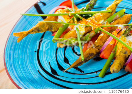Fried in batter sprats with creamy ginger sauce, tomatoes, balsamic paste 119576480