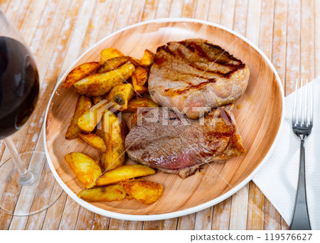 Delicious roasted veal chop served with potato Delicious roasted veal chop served with potato 119576627