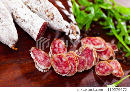 Traditional spanish thin salami sausage Fuet, sliced 119576672