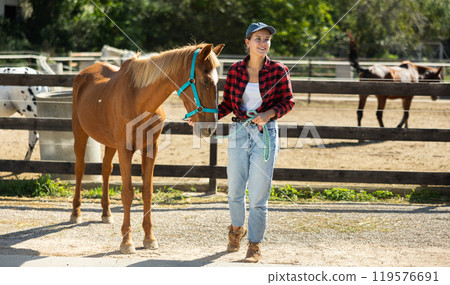Young woman with horse in horse pen Young woman with horse in horse pen 119576691