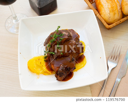 Pork chop in wine sauce with sliced potato served in a plate Pork chop in wine sauce with sliced potato served in a plate 119576700