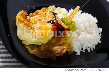 Vegetarian leaves of cabbage in batter with rice and green sauce Vegetarian leaves of cabbage in batter with rice and green sauce 119576703