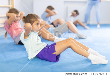 Children engage in abdominal exercises 119576991