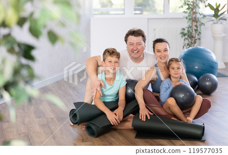 Family with two children posing with pilates equipment 119577035
