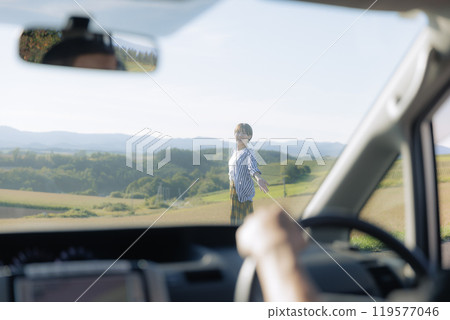 Young woman walking out of a car 119577046