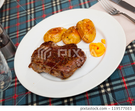 Portion of just cooked beef steak with potatoes Portion of just cooked beef steak with potatoes 119577083