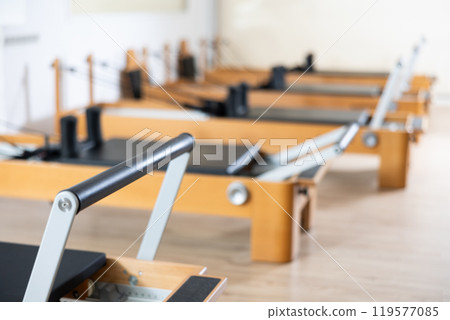 Close-up of modern Pilates reformer machine in fitness studio 119577085