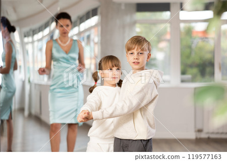 Boy with pair girl in sport wear train to dance contemporary vigorous hustle during classes. Boy with pair girl in sport wear train to dance contemporary vigorous hustle during classes. 119577163