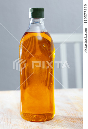 Vegetable oil on wooden table 119577259