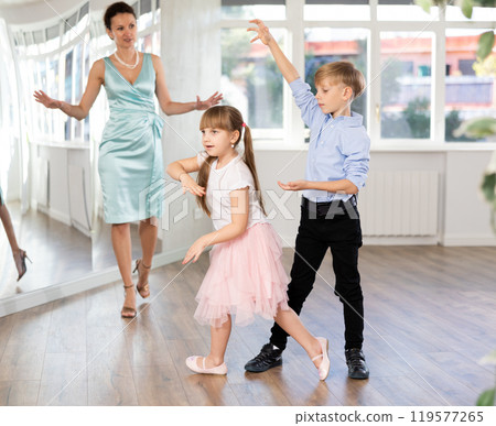 Boy and girl in pair train to dance contemporary vigorous hustle during classes. Boy and girl in pair train to dance contemporary vigorous hustle during classes. 119577265