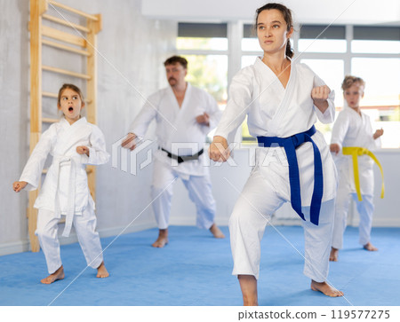 Children with parents during karate training. Martial arts. Sport, active lifestyle concept Children with parents during karate training. Martial arts. Sport, active lifestyle concept 119577275