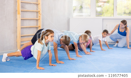 Children are performing push-ups Children are performing push-ups 119577405