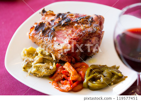 Broiled pork knuckle with vegetable garnish Broiled pork knuckle with vegetable garnish 119577451
