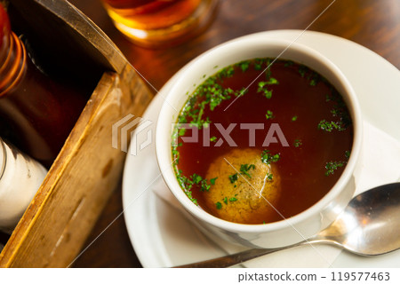 Dish of Austrian cuisine is homemade beef soup with liver meatballs 119577463