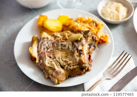 Grilled pork meat with roasted potatoes and braised cabbage Grilled pork meat with roasted potatoes and braised cabbage 119577485