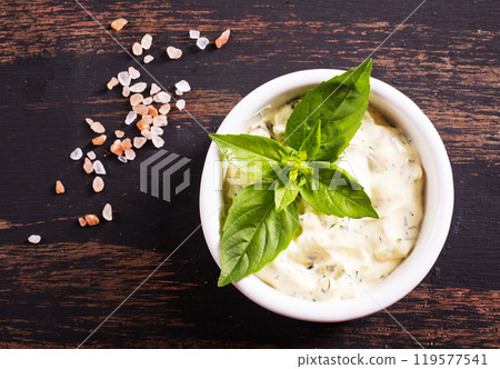 Garlic sauce with basil, ingredients and snack on wooden background 119577541