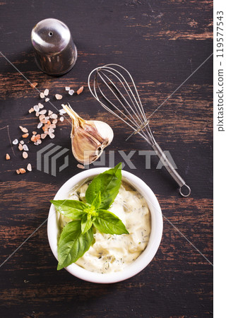 Garlic sauce with basil, ingredients and snack on wooden background Garlic sauce with basil, ingredients and snack on wooden background 119577543