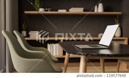 A side view of a laptop on a black dining table or meeting table in a contemporary luxurious room. A side view of a laptop on a black dining table or meeting table in a contemporary luxurious room. 119577640