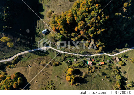 Aerial view of rural dirt village road in autumn 119578038