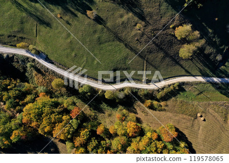 Aerial view of rural dirt village road in autumn Aerial view of rural dirt village road in autumn 119578065