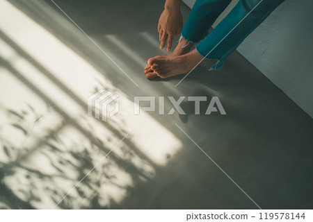 Barefoot woman and window light 119578144