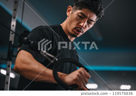 Man using a machine to train at the gym 119578836