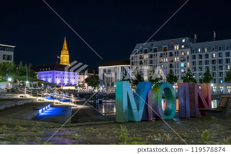 Kiel city centre bootshafen basin with town hall tower in background illuminated by night and Moin Sign german for Hello 119578874