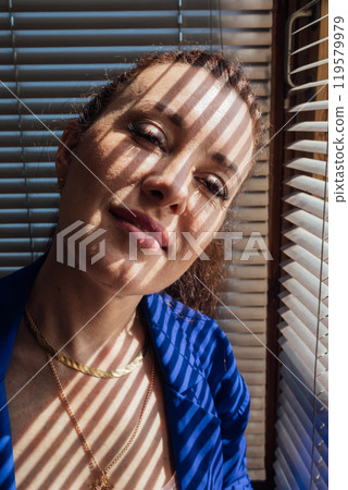 Beautiful brunette woman and blind light and shadow Beautiful brunette woman and blind light and shadow 119579979
