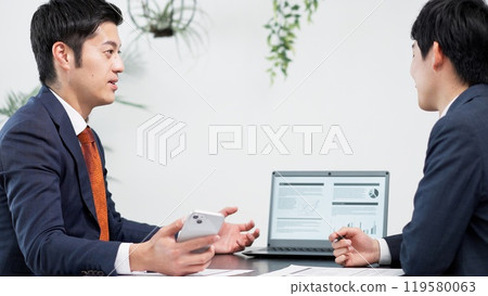 Businessman using smartphone at a meeting 119580063