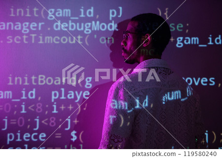 Examining Computer Code Projected on Wall 119580240