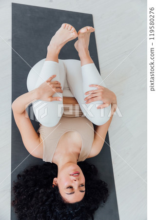 Relaxe harmonious beautiful brunette woman yoga instructor standing in anjaneyasana pose, 119580276