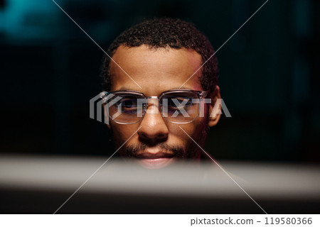 Focused African American Male Wearing Glasses at Computer 119580366
