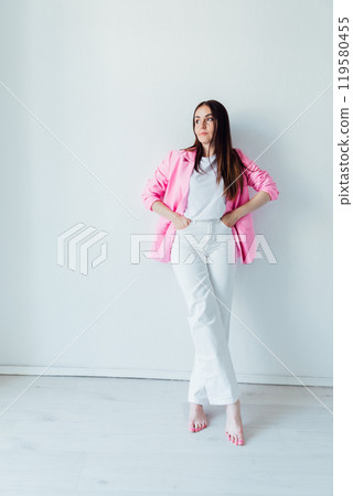 Beautiful Fashion Brunette Woman in Pink Jacket on White Background 119580455
