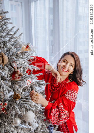 beautiful woman in ukrainian traditional clothes decorating christmas tree beautiful woman in ukrainian traditional clothes decorating christmas tree 119581336