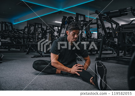 man stretching at the gym man stretching at the gym 119582055