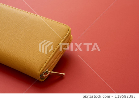 Yellow wallet on a red background 119582385