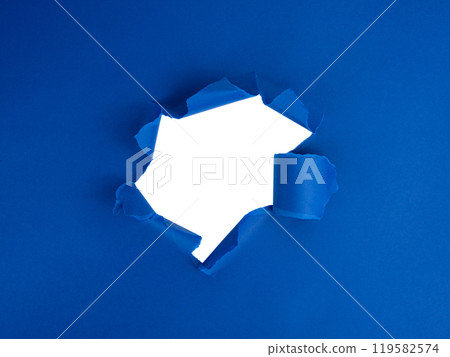 Blue torn sheet of paper with whole space for text 119582574
