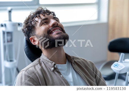 Attractive young man with cheerful smile showing his teeth undergoes orthodontic treatment Attractive young man with cheerful smile showing his teeth undergoes orthodontic treatment 119583130