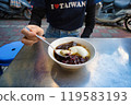 A woman scooping douhua in Taiwan 119583193