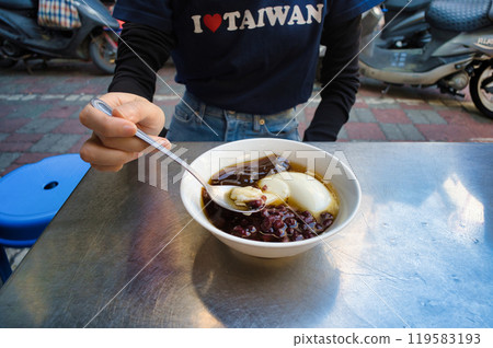 A woman scooping douhua in Taiwan A woman scooping douhua in Taiwan 119583193